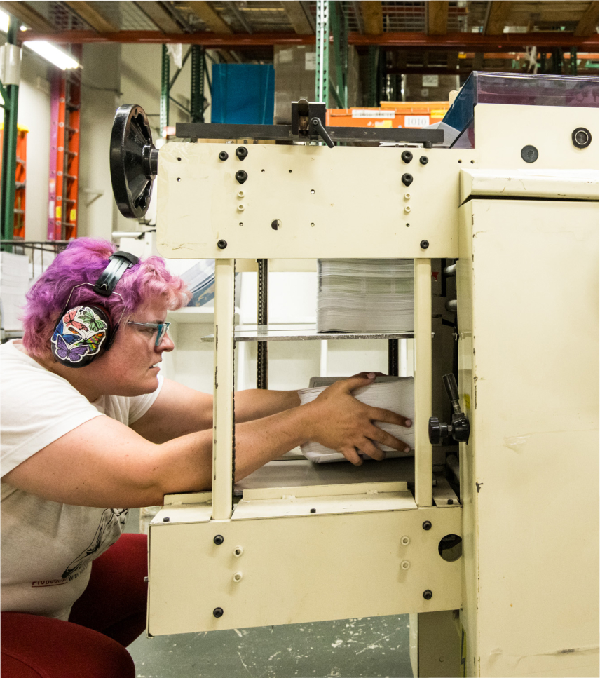 worker loading a machine